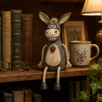 A rustic figurine of a donkey on a plank with rope legs hanging down