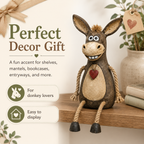 A rustic figurine of a donkey on a plank with rope legs hanging down